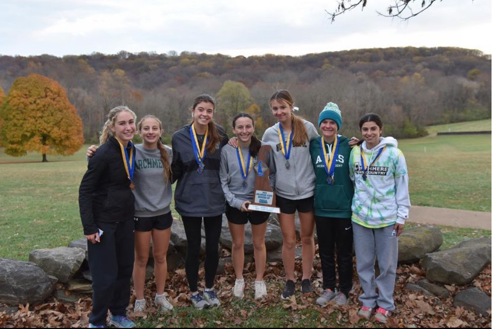 The girls varsity cross country team with their runners up trophy after an exciting state championship meet! 
